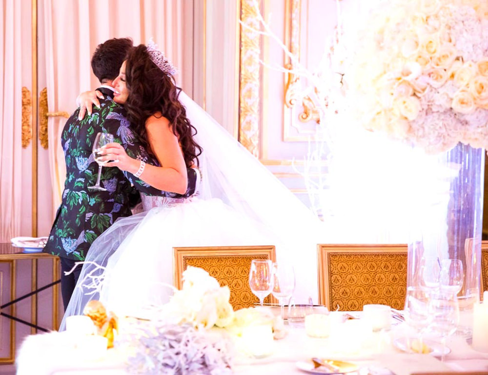 Bride hugging her event planner during wedding reception