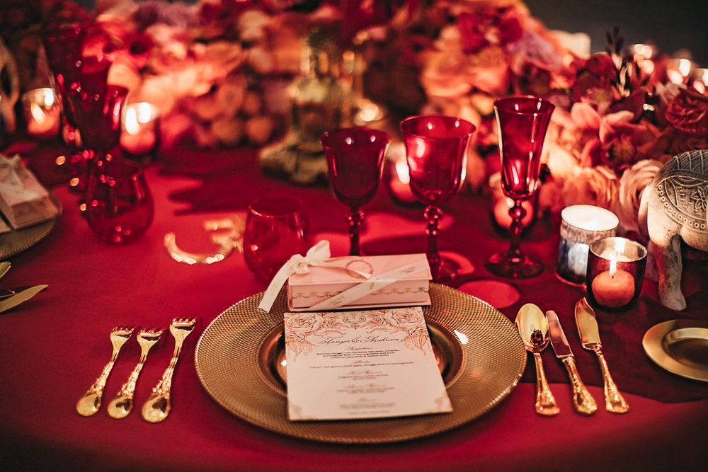 Candles, silverware and French Macaroons on reception table