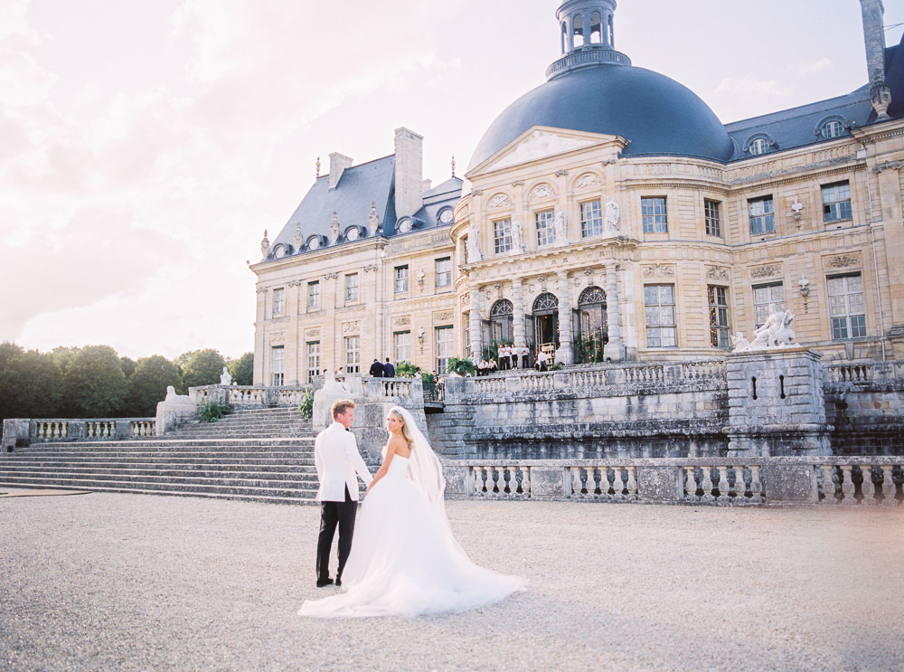 French Wedding - Bride and groom walking to their French Chateau wedding