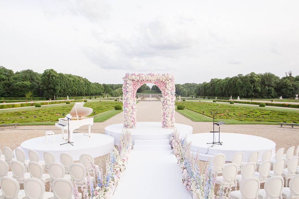 Wedding ceremony setup with pink and while flowers at Vaux le Vicomte French chateau